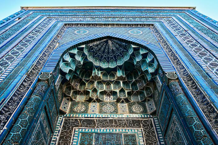 Intricate blue tilework on an ancient building, showcasing lesser-known facts about these countries through stunning architecture.