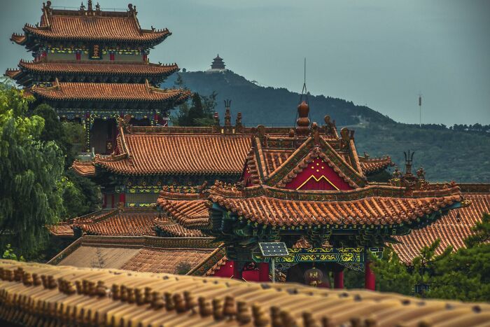 Ancient Asian temple rooftops with intricate designs highlighting lesser-known facts about countries and cultures.