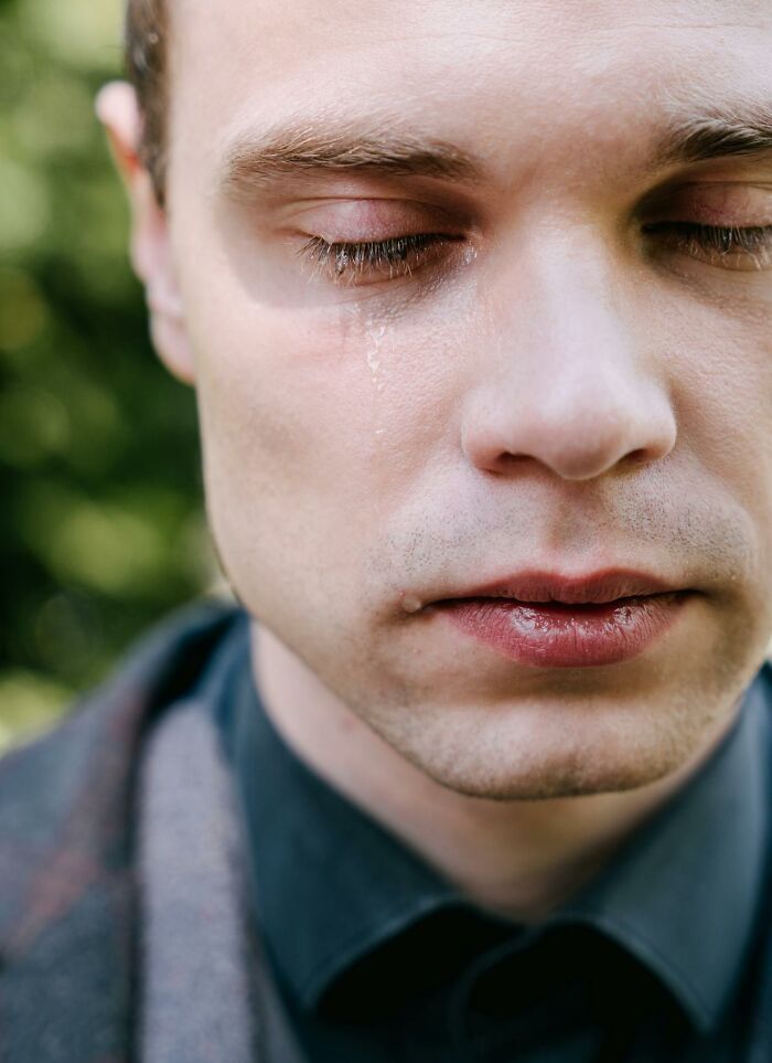 Close-up of a man with a tear on his cheek, reflecting the emotion of 3 AM chaos during the night shift.