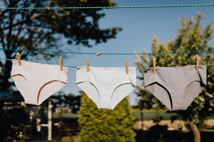 Three pairs of underwear hanging on a clothesline outdoors representing accidental texts that sent people into a panic.