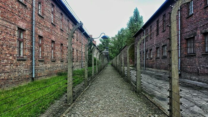 Barbed wire fence and brick buildings representing lesser-known facts about these countries with historical significance.
