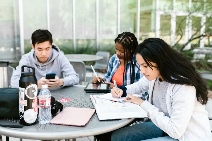 Three students studying together outdoors, sharing moments so ridiculous people thought they were being pranked.