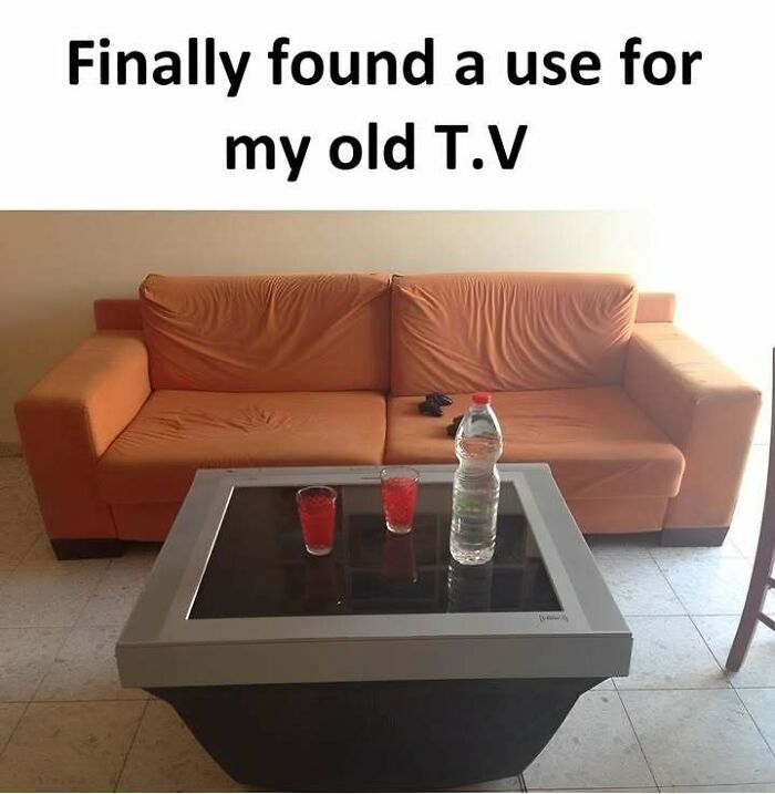 Old TV repurposed as a table in front of couch, capturing the humor of Eastern European funny pics and memes experience.