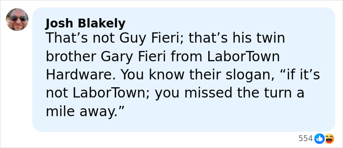 Man resembling Guy Fieri with spiky blonde hair, wearing sunglasses and a black shirt, smiling in an outdoor setting. Man resembling Guy Fieri with spiky blonde hair, wearing sunglasses and a black shirt, smiling in an outdoor setting.