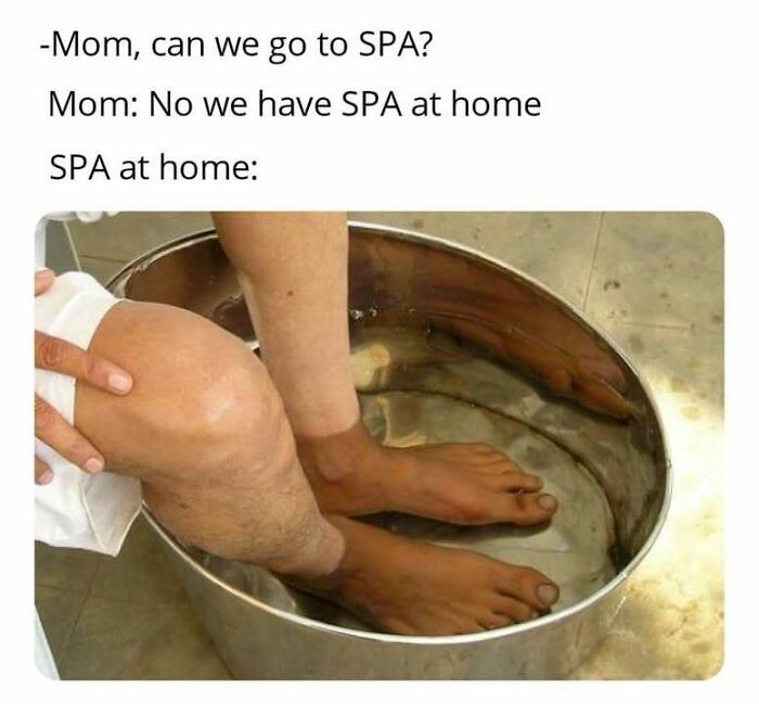 Person soaking feet in a metal basin illustrating a funny Eastern European experience meme about home SPA alternatives.