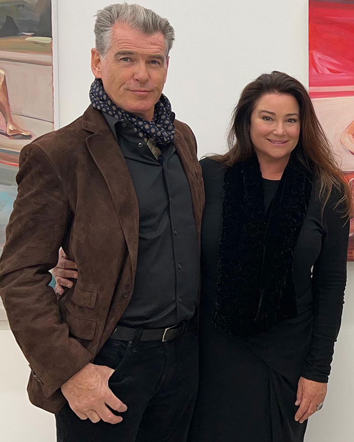 Pierce Brosnan and his wife pose indoors, highlighting public reaction to his wife's transformation and marriage reminder.