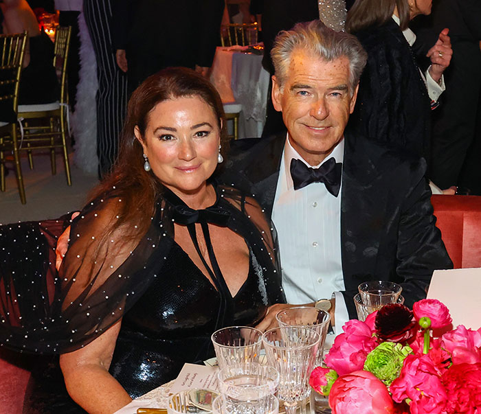 Pierce Brosnan's wife, 62, dressed elegantly at an event, facing online trolls over her transformation and marriage.