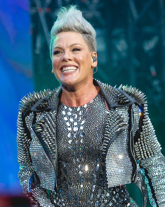Pink smiling on stage wearing a studded outfit, breaking silence after spending New Year’s Eve alone in hospital. Pink smiling on stage wearing a studded outfit, breaking silence after spending New Year’s Eve alone in hospital.