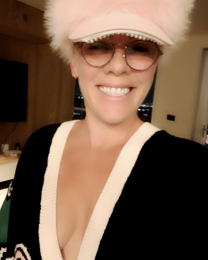 Pink smiling in a hat and glasses, breaking silence after spending New Year’s Eve alone in hospital, indoors selfie. Pink smiling in a hat and glasses, breaking silence after spending New Year’s Eve alone in hospital, indoors selfie.