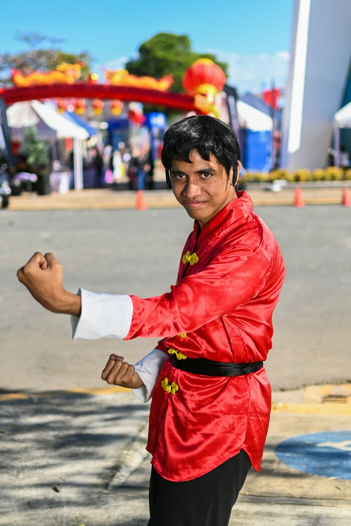 Man in red martial arts outfit posing outdoors, illustrating themes related to former cult members and cult awareness.