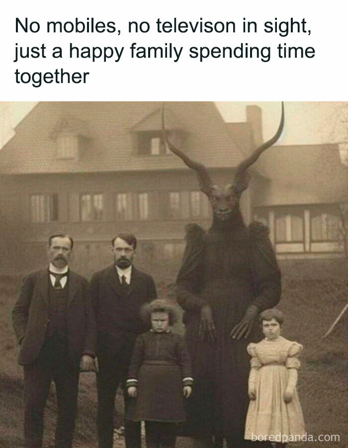 Vintage family photo with two men, two girls, and a creature with large horns in a black outfit, funny memes surreal humor.