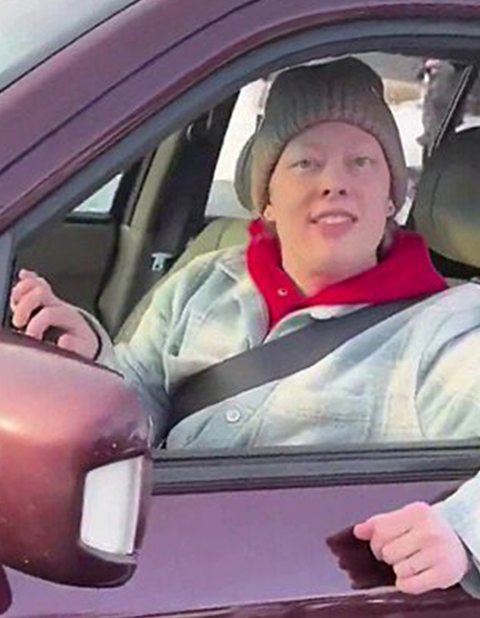 Person wearing a beanie and jacket sitting in a car, related to Renee Good’s wife breaking silence on fatal ICE incident. Person wearing a beanie and jacket sitting in a car, related to Renee Good’s wife breaking silence on fatal ICE incident.