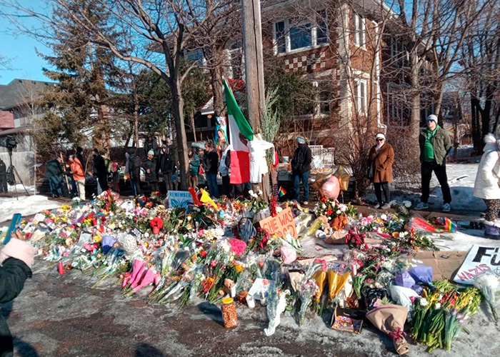 Memorial site with flowers and signs where Renee Good&rsquo;s wife speaks out on fatal ICE incident in the community.