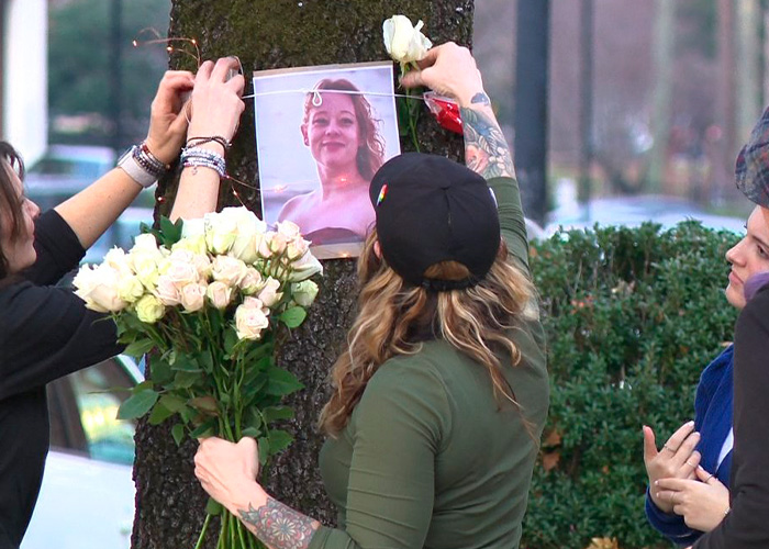 People placing flowers and a photo on a tree during a vigil for Renee Good’s wife after fatal ICE incident. People placing flowers and a photo on a tree during a vigil for Renee Good’s wife after fatal ICE incident.