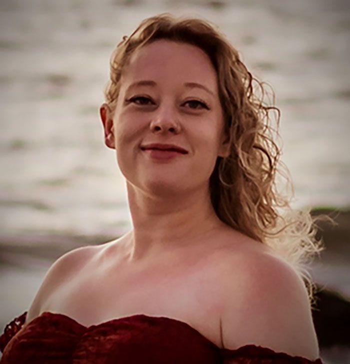 Woman identified as mom of a 6-year-old, slain by ICE, posing outdoors with a blurred water background. Woman identified as mom of a 6-year-old, slain by ICE, posing outdoors with a blurred water background.