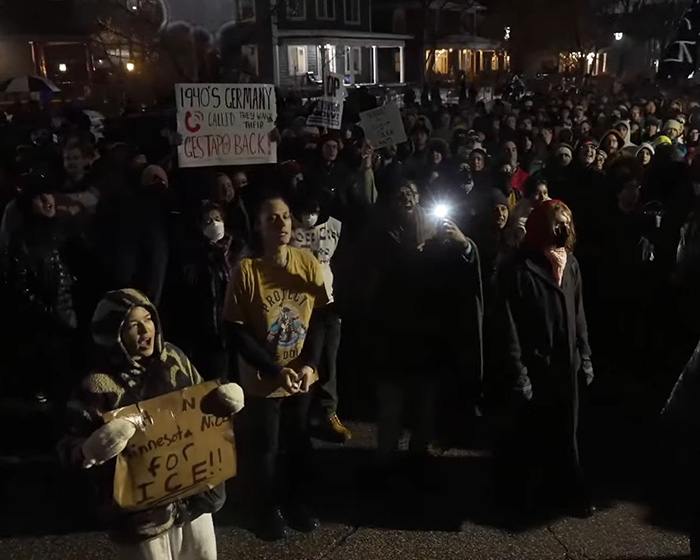Protesters gathered at night holding signs demanding justice and context for the fatal shooting involving ICE. Protesters gathered at night holding signs demanding justice and context for the fatal shooting involving ICE.