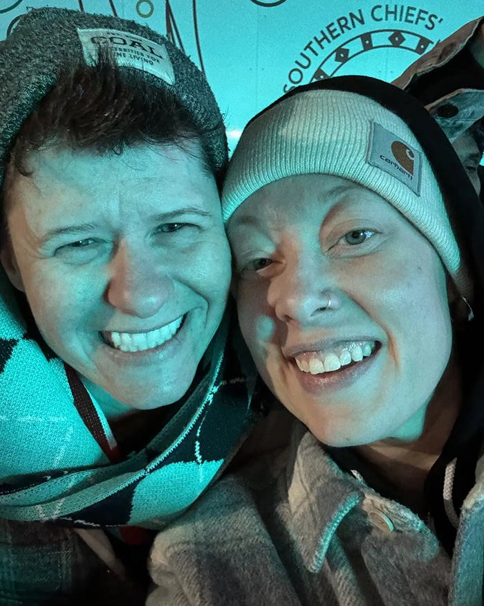 Two people smiling closely, both wearing beanies, illustrating context related to newly released ICE video. Two people smiling closely, both wearing beanies, illustrating context related to newly released ICE video.