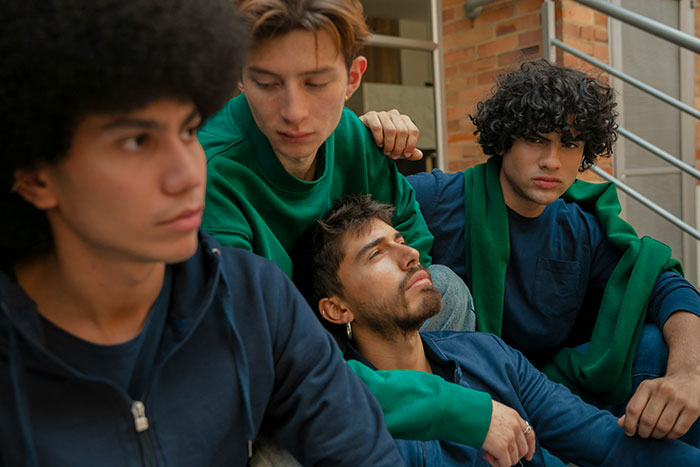 A group of teens sitting on stairs, showing support and empathy during a moment of grief and emotional struggle. A group of teens sitting on stairs, showing support and empathy during a moment of grief and emotional struggle.