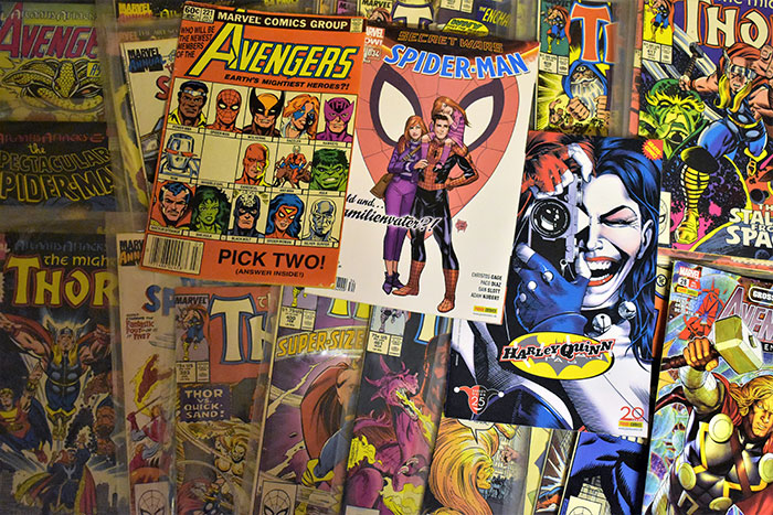 A collection of Marvel superhero comic books including Avengers, Spider-Man, and Thor piled together. A collection of Marvel superhero comic books including Avengers, Spider-Man, and Thor piled together.