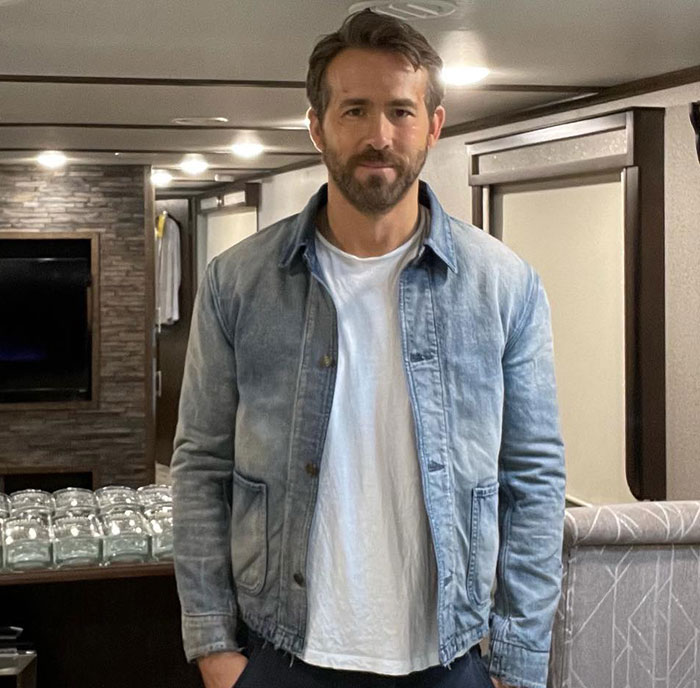 Ryan Reynolds standing indoors wearing a denim jacket and white t-shirt, related to manipulative email leak news. Ryan Reynolds standing indoors wearing a denim jacket and white t-shirt, related to manipulative email leak news.