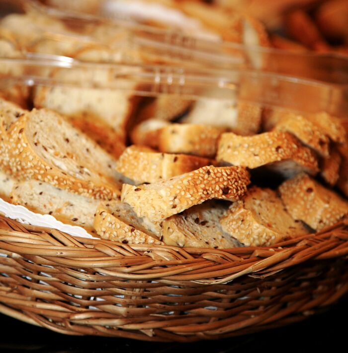 Basket of sliced multigrain bread rolls showcasing a common scene in service industry food preparation and presentation.