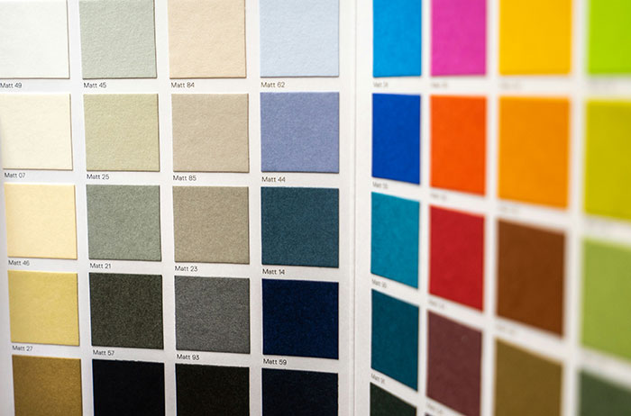 Paint chip color swatches arranged in a grid on a sample book, saw images on google