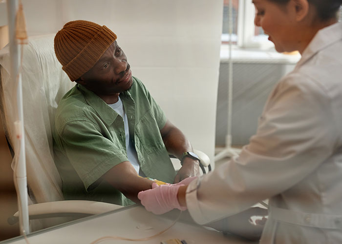 Patient receiving IV treatment from healthcare professional, reflecting on terrifying close calls and life-changing moments.