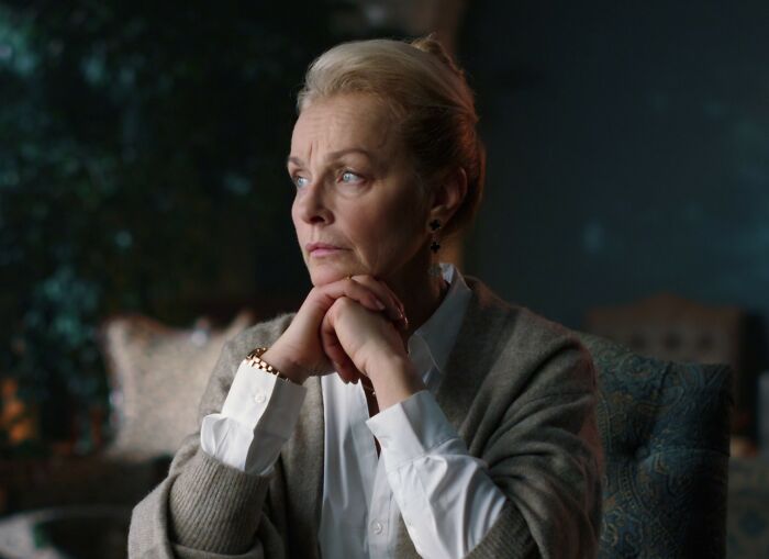 Middle-aged woman deep in thought at home, reflecting on mom inviting son’s girlfriend to dad’s party situation. Middle-aged woman deep in thought at home, reflecting on mom inviting son’s girlfriend to dad’s party situation.