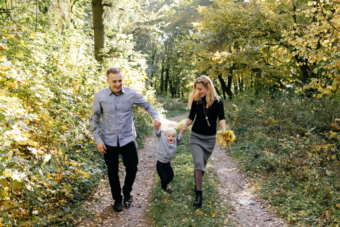 Family walking on forest path enjoying time together with stepson, discussing college and family money matters. Family walking on forest path enjoying time together with stepson, discussing college and family money matters.