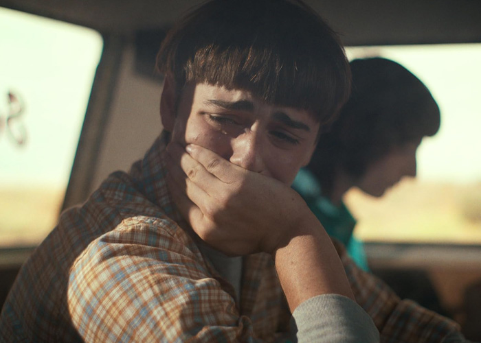 Noah Schnapp portraying Will Byers in Stranger Things, looking distressed inside a vehicle with another character blurred. Noah Schnapp portraying Will Byers in Stranger Things, looking distressed inside a vehicle with another character blurred.