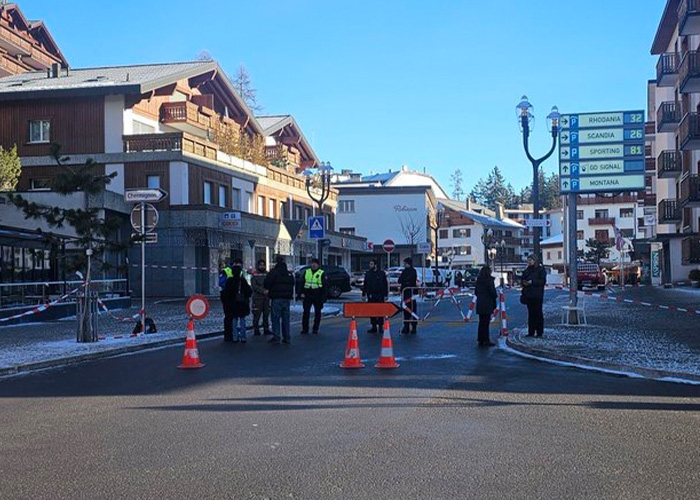 Ski resort explosion site with emergency responders and blocked streets in a winter mountain village town scene. Ski resort explosion site with emergency responders and blocked streets in a winter mountain village town scene.