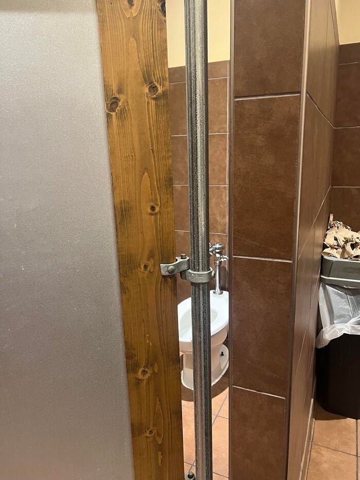 Public restroom stall with a large gap between door and wall, illustrating normal things in America but offensive elsewhere.