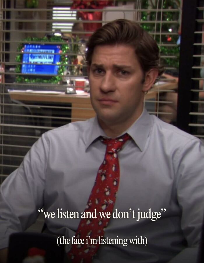 Man from The Office wearing a red tie with penguins, sitting in an office with a serious expression, meme format.