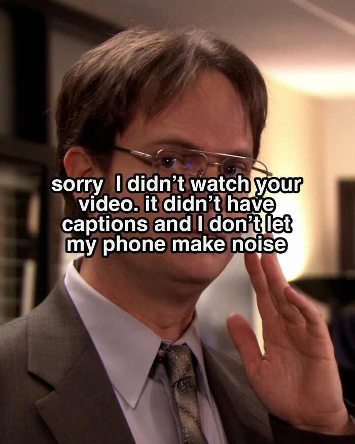 Character from The Office in a suit making a hand gesture with a meme about not watching videos without captions.