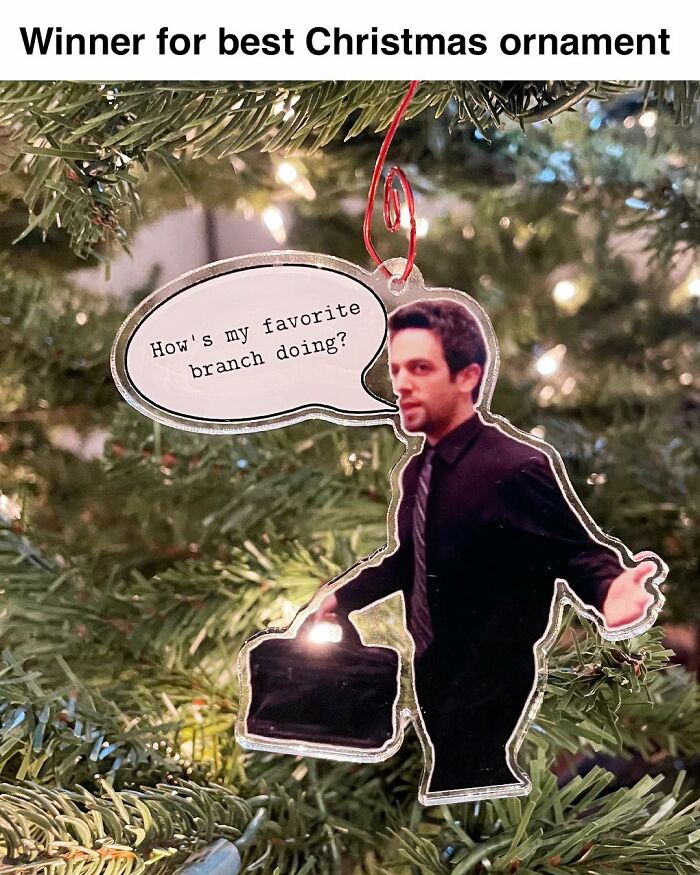 Christmas ornament of a man in a suit holding a briefcase with a speech bubble, inspired by The Office TV series memes.