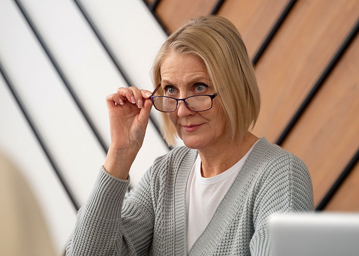 Experienced recruiter with glasses assessing job candidates in a modern office, revealing key hiring insights. Experienced recruiter with glasses assessing job candidates in a modern office, revealing key hiring insights.