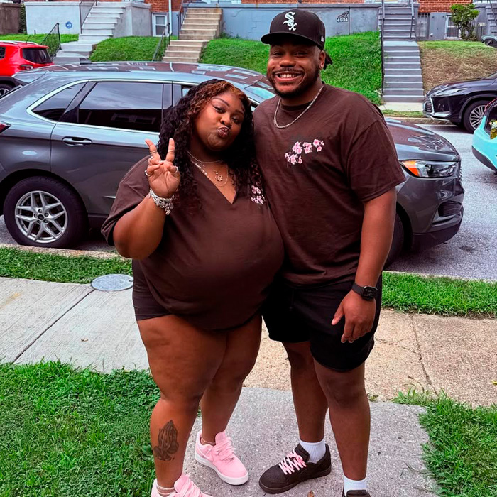 TikTok influencer and friend posing outside near cars, involved in $1.75M lawsuit over inappropriate act in couple&rsquo;s home.