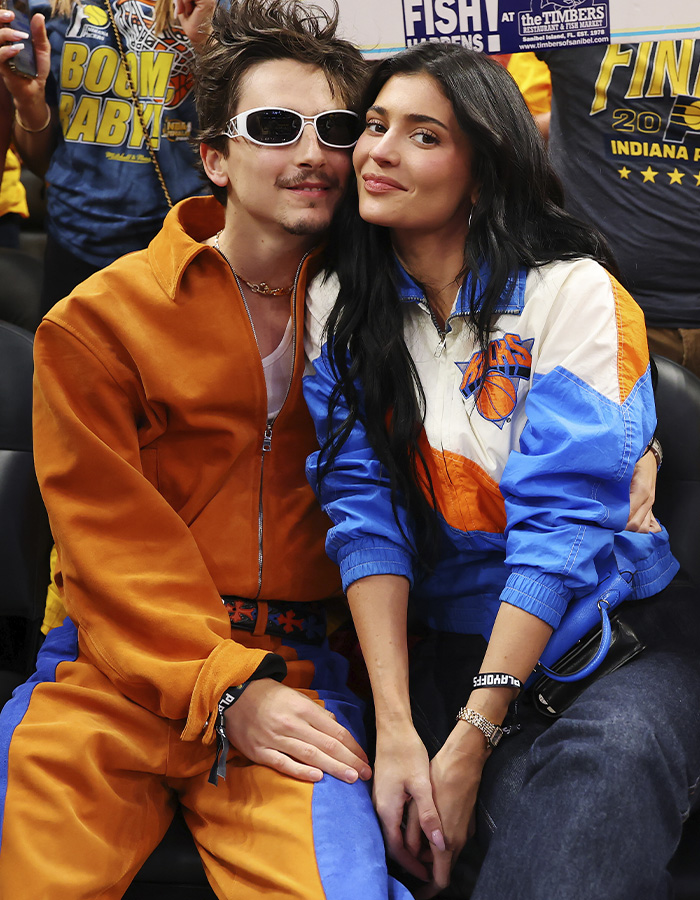 Timoth&eacute;e Chalamet and Kylie Jenner sitting close together at a sports event, sparking buzz with their outing.