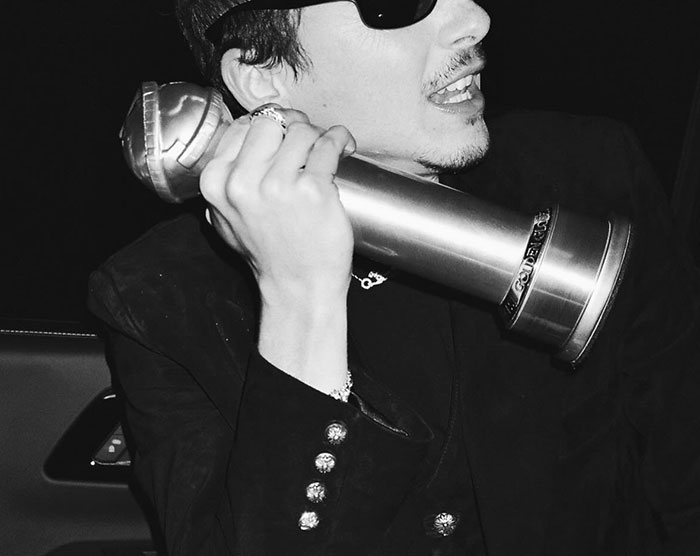 Timothée Chalamet holding a Golden Globe award, dressed in black, reacting during an event amid media attention. Timothée Chalamet holding a Golden Globe award, dressed in black, reacting during an event amid media attention.