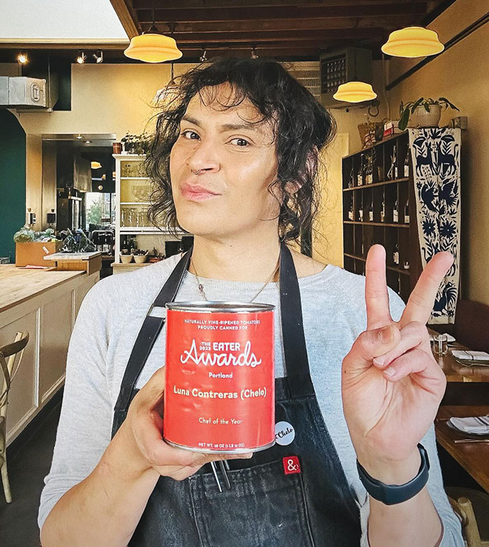Person holding Chef of the Year award in a restaurant setting, related to trans chef controversy in media coverage. Person holding Chef of the Year award in a restaurant setting, related to trans chef controversy in media coverage.