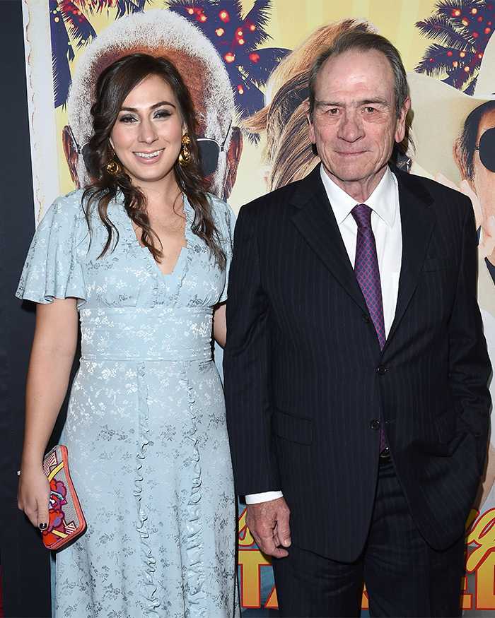 Tommy Lee Jones and his daughter Victoria posing together at a formal event with a colorful backdrop. Tommy Lee Jones and his daughter Victoria posing together at a formal event with a colorful backdrop.