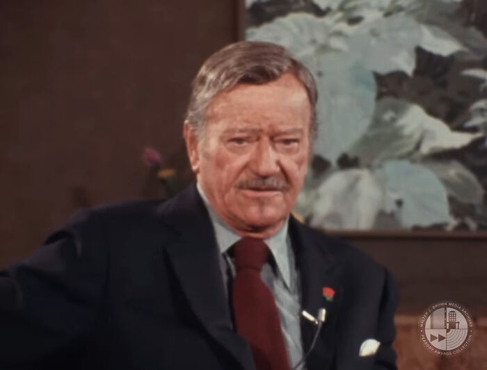 Portrait of an older man in a suit, symbolizing people who met their idols in real life and regretted it deeply.