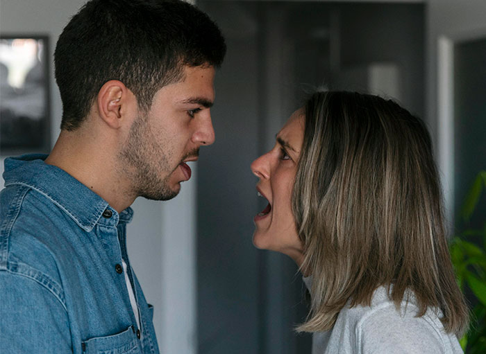 Couple arguing intensely indoors, representing conflict about open marriage and reconnecting with an ex partner. Couple arguing intensely indoors, representing conflict about open marriage and reconnecting with an ex partner.
