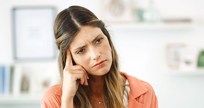 Woman looking appalled and thoughtful, reflecting family drama involving chauvinist brother and gaslighting mom. Woman looking appalled and thoughtful, reflecting family drama involving chauvinist brother and gaslighting mom.