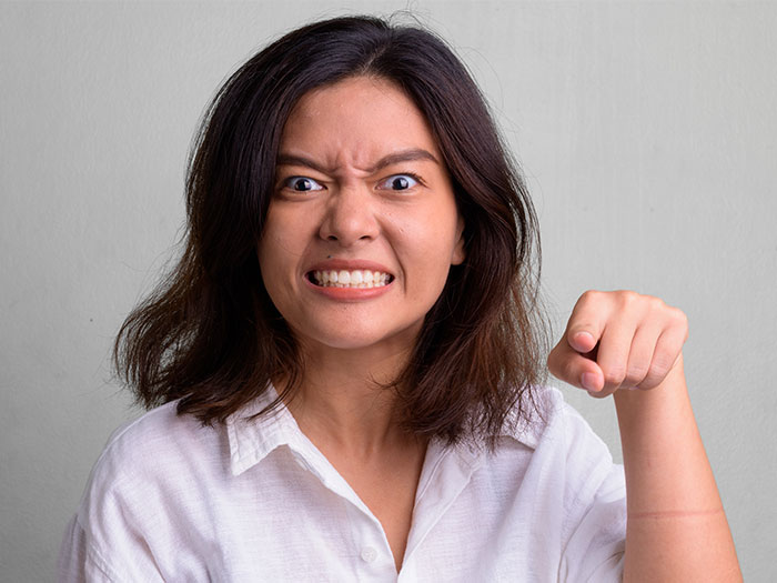 Woman frowning and pointing with frustration, shocked by proposal and arranged marriage in India after plane arrival. Woman frowning and pointing with frustration, shocked by proposal and arranged marriage in India after plane arrival.