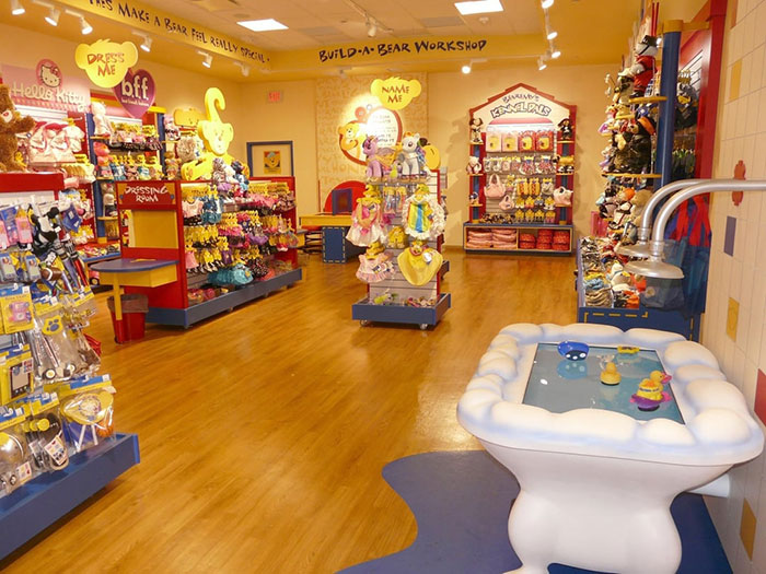 Interior of a colorful toy store with a play area, showcasing a bright and inviting space for children and families.