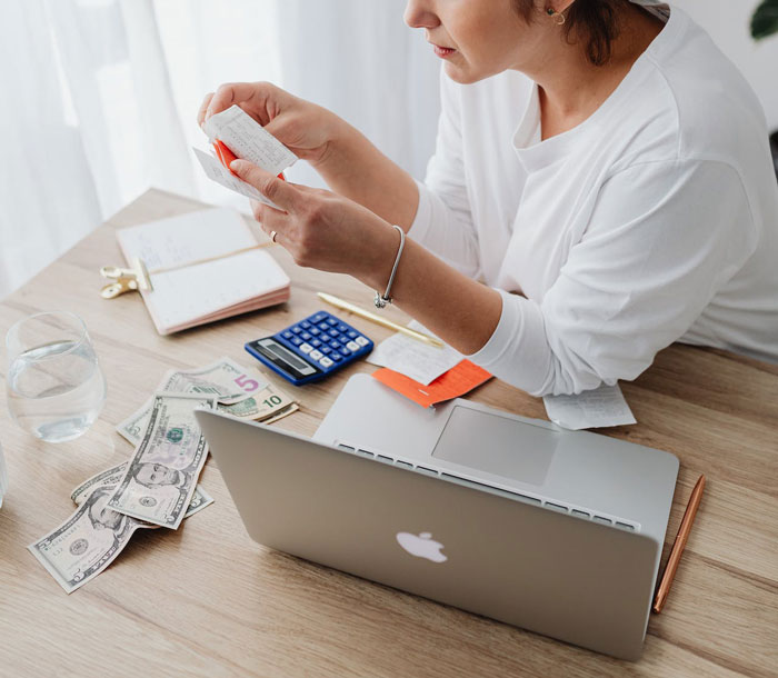 Woman managing budget and receipts at home, concerned about food expenses saved for their kids and relationship issues. Woman managing budget and receipts at home, concerned about food expenses saved for their kids and relationship issues.
