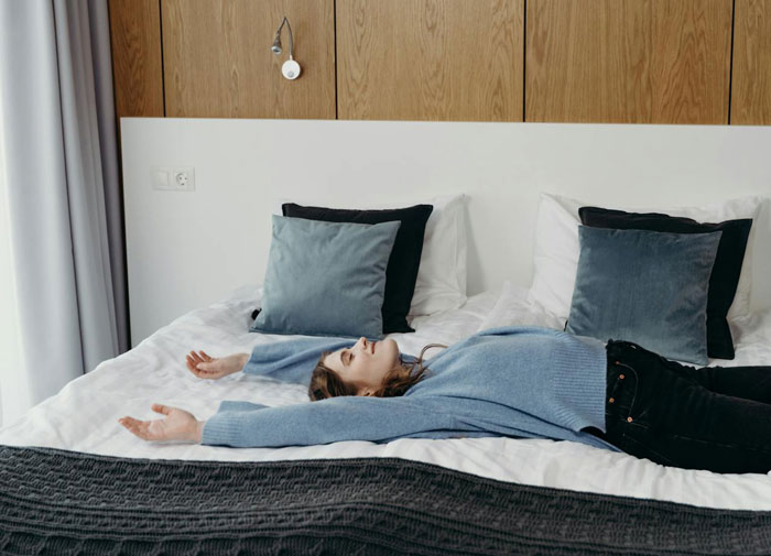 Woman lying on bed appearing stressed and overwhelmed after snapping and kicking fiancé and stepdaughter out Woman lying on bed appearing stressed and overwhelmed after snapping and kicking fiancé and stepdaughter out