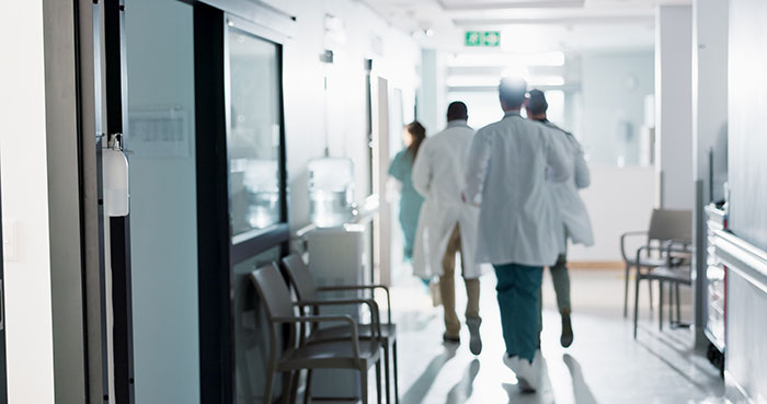 Medical professionals walking in a hospital corridor highlighting heartbreaking medical conditions that can’t be cured.