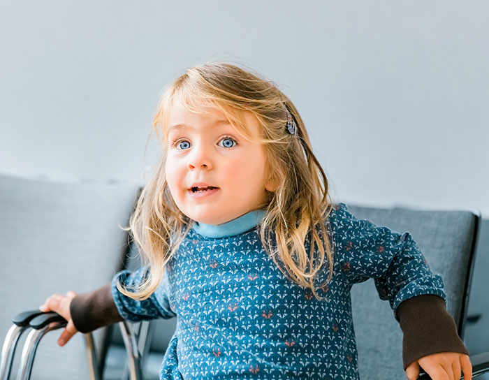 Young girl with wheelchair, illustrating heartbreaking medical conditions that can't be cured affecting children.